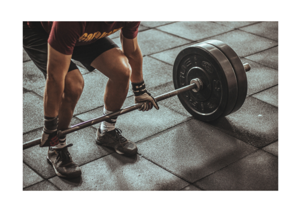Personal trainer guiding man over 50 through safe resistance training.